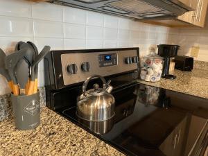 a tea kettle on a stove in a kitchen at Coastal Comfort in Jacksonville