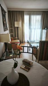 a hotel room with a bed with a vase on it at STRAVINSKY Apartments Avignon - Get our Last best deals ! in Avignon