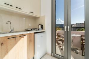 a kitchen with a view of a balcony at Lena Apartments in Elounda