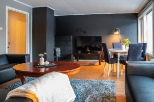 a living room with a couch and a table at Apartment in Senja in Senja
