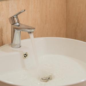 a sink with water running from a faucet at Casa De Coral Boutique Hotel in Kata Beach +39 photos