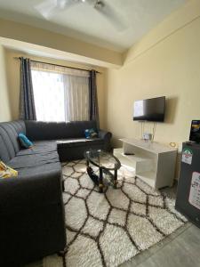 a living room with a couch and a coffee table at Milly's apartment in Malindi +1 photo
