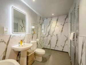 a bathroom with a toilet and a sink at Nith Riverside Cottages in Sanquhar +24 photos