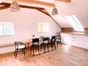 a kitchen and dining room with a table and chairs at Klobucká manufaktura in Valašské Klobouky