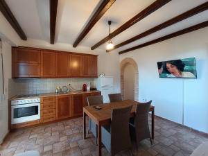 a kitchen with wooden cabinets and a wooden table at Aura di Mare in Barbati +18 photos