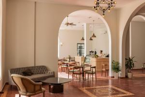 an archway in a restaurant with tables and chairs at Chateau Kampot in Kampot