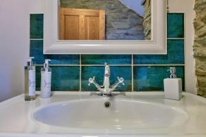 a sink in a bathroom with a mirror above it at Finest Retreats - Garreg Ddu in Blaenau-Ffestiniog +18 photos