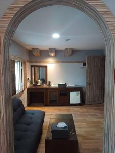 an archway in a living room with a couch and a table at Hotelharu in Eumseong