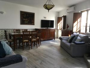 a living room with a couch and a table with chairs at Maresia in Sines