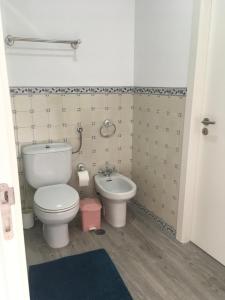 a bathroom with a toilet and a bidet at Maresia in Sines +23 photos