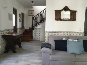 a living room with a couch and a mirror at Maresia in Sines