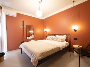a bedroom with orange walls and a bed at Ruby Hostel, Kutaisi - Private & Shared Rooms in Kutaisi
