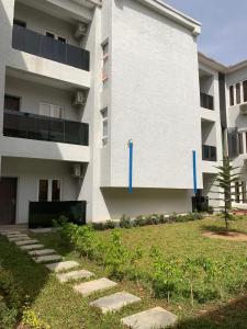 a building with blue tape on the side of it at Saadatus Apartment in Kaduna
