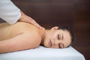 a man giving a young boy a massage at Spazio Marine Hotel - Guaratuba in Guaratuba