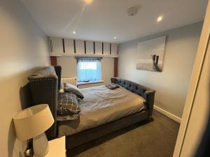 a bedroom with a bed and a chair at Seaview Terrace in Skerries