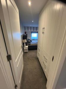 a room with a closet and a bedroom with a bed at Seaview Terrace in Skerries +5 photos