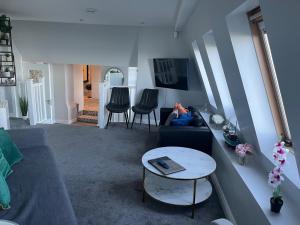 a living room with a couch and a table at Seaview Terrace in Skerries