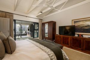 a bedroom with a bed and a flat screen tv at Inverell Station by The Oyster Collection in Kenton on Sea
