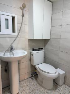a bathroom with a white toilet and a sink at Cozy Studio Cheonho in Seoul
