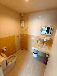 a bathroom with a toilet and a sink and a tv at Banana Bunkhouse Hostel in Rawai Beach +34 photos