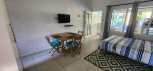a room with a table and chairs and a bed at HAPPY JUNGLE at 6 in St Lucia