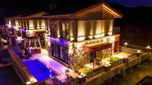 an aerial view of a house at night with a swimming pool at champion villas in Ortaca