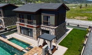 an aerial view of a house with a swimming pool at champion villas in Ortaca