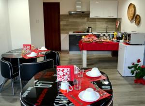 a kitchen with a table and chairs and a kitchen with a counter at B&B La Casa Bianca di Porto Conte in Porto Conte