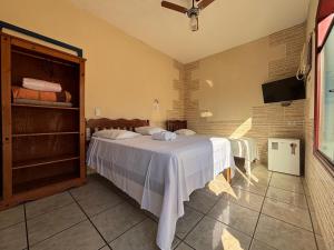 a bedroom with a white bed in a room at Pousada Lua Clara in Paraty