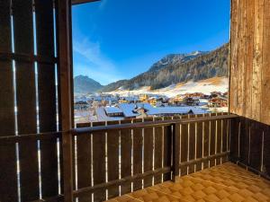a view from the balcony of a mountain village at Begar Nest - ski slope front and panoramic in Sappada