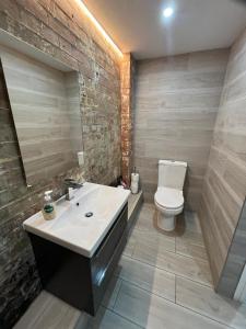 a bathroom with a white sink and a toilet at The Captains Wheel in Skerries