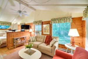 a living room with a couch and a bed at 'Pine Cottage' Duplex w/ Deck: Walk to State Park! in Ephraim