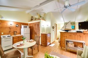 a kitchen with a table and a stove and a refrigerator at 'Pine Cottage' Duplex w/ Deck: Walk to State Park! in Ephraim +16 photos