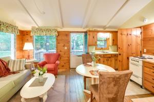 a kitchen and living room with a couch and a table at 'Pine Cottage' Duplex w/ Deck: Walk to State Park! in Ephraim