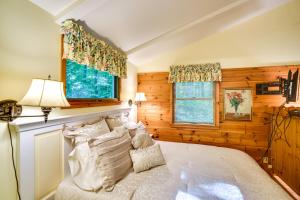 a bedroom with a white bed and a window at 'Pine Cottage' Duplex w/ Deck: Walk to State Park! in Ephraim