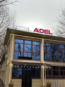 a building with a sign on top of it at Adel in Almaty