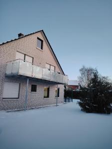 a building with snow on the ground in front of it at Apartment 28 in Stadthagen