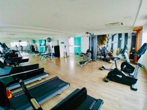 a gym with several treadmills and exercise bikes at Flat Ilha do Leite in Recife