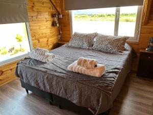a bedroom with a bed with two towels on it at La Loica in El Maitén