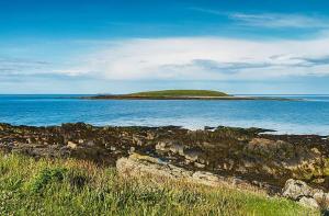 a small island in the middle of the ocean at The Captains Wheel in Skerries +10 photos