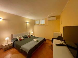 a bedroom with a bed and a television in it at Bungalow Punta in Umag