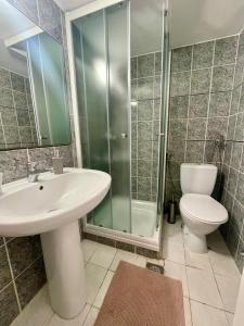 a bathroom with a sink and a toilet and a shower at Bungalow Punta in Umag +18 photos