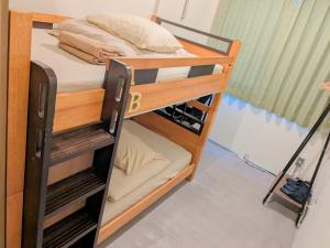 a couple of bunk beds in a room at Hostel JIN in Osaka
