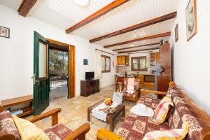 a living room with a couch and a table at Villa Old Vineyard in Kontogiannátika