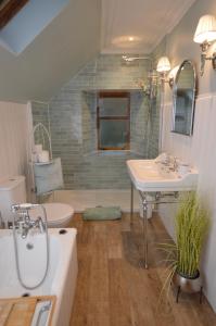 a bathroom with two sinks and a tub and a toilet at Aldersyde in Tighnabruaich +21 photos