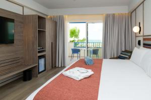 a hotel room with a bed with a towel on it at Occidental Boa Vista Beach in Rabil