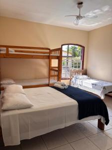 a bedroom with two bunk beds and a window at Pousada Lua Clara in Paraty +31 photos