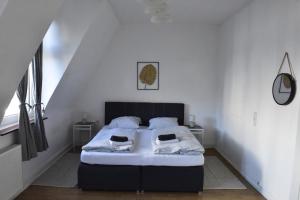 a bedroom with a bed with white walls at Fewo Wuppertal in Wuppertal