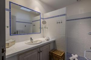 a bathroom with a sink and a mirror at Les Restanques in Paradou +9 photos