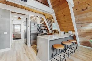 a kitchen with wooden ceilings and a counter with stools at Elati Escape in South Lake Tahoe